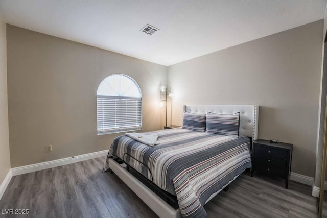 bedroom with dark wood-type flooring