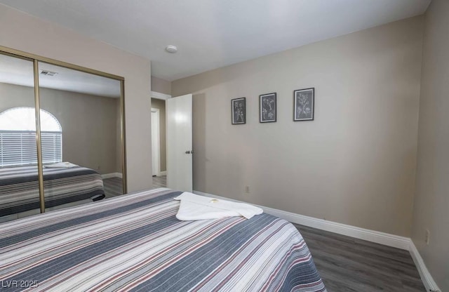 bedroom featuring dark wood-type flooring and a closet