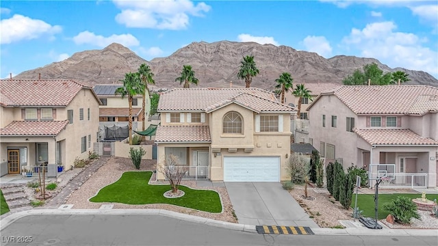 mediterranean / spanish house with a garage and a mountain view