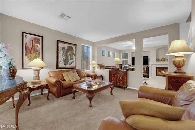 carpeted living room featuring ceiling fan