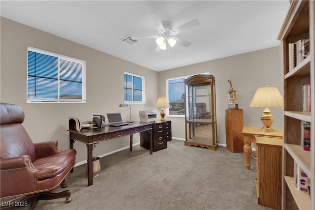 office area featuring light carpet and ceiling fan