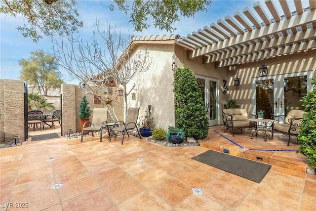 view of patio / terrace with french doors and a pergola