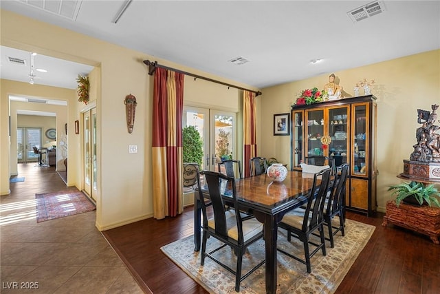 dining area featuring french doors and dark hardwood / wood-style floors