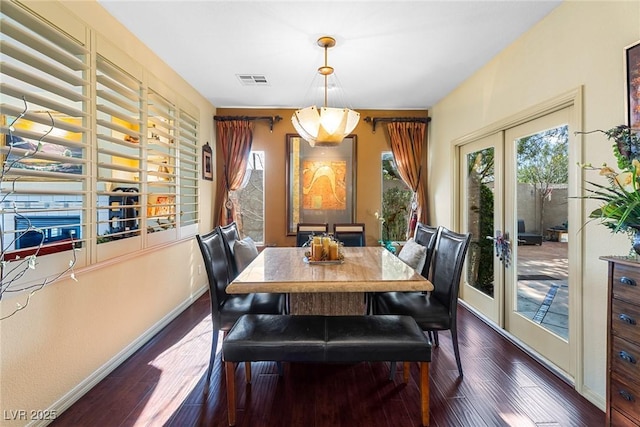 dining area featuring dark wood-type flooring and french doors