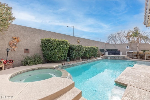 view of swimming pool featuring an in ground hot tub