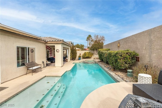 view of swimming pool with an in ground hot tub and a patio area