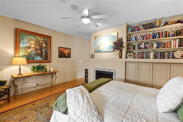 bedroom featuring hardwood / wood-style flooring and ceiling fan