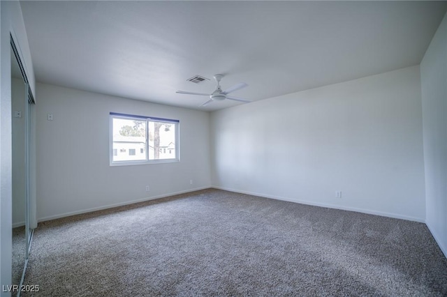 unfurnished room featuring ceiling fan and carpet flooring