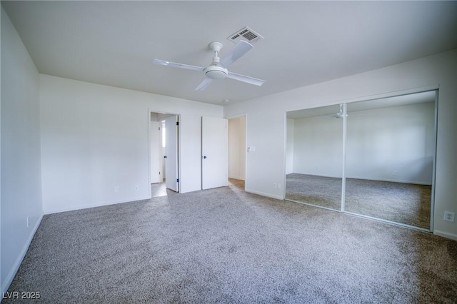 unfurnished bedroom featuring ceiling fan, carpet flooring, and a closet