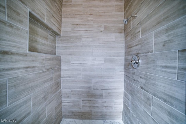 bathroom with tiled shower