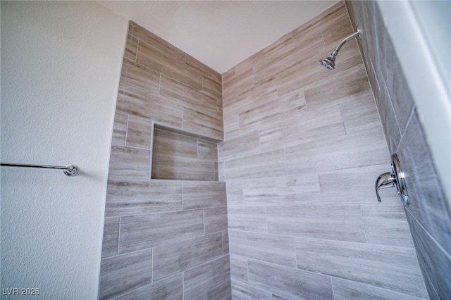 bathroom featuring tiled shower