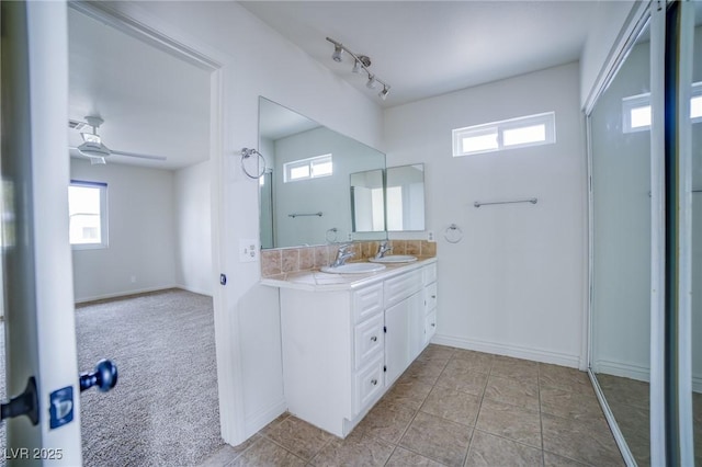 bathroom with ceiling fan, track lighting, vanity, and tile patterned flooring