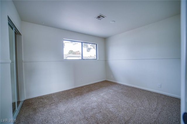 unfurnished room with carpet flooring