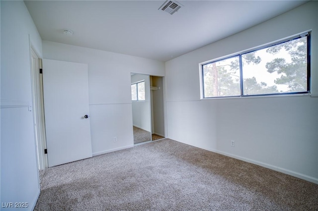 unfurnished bedroom with carpet floors and a closet