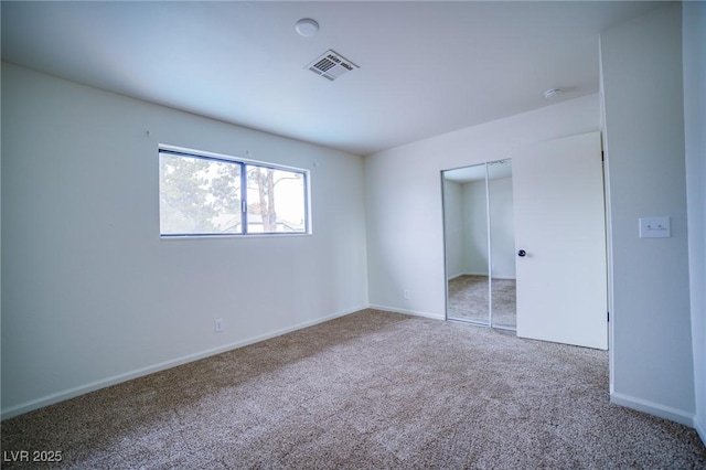 unfurnished bedroom featuring a closet and carpet