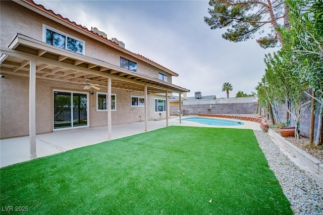 view of yard with a fenced in pool and a patio