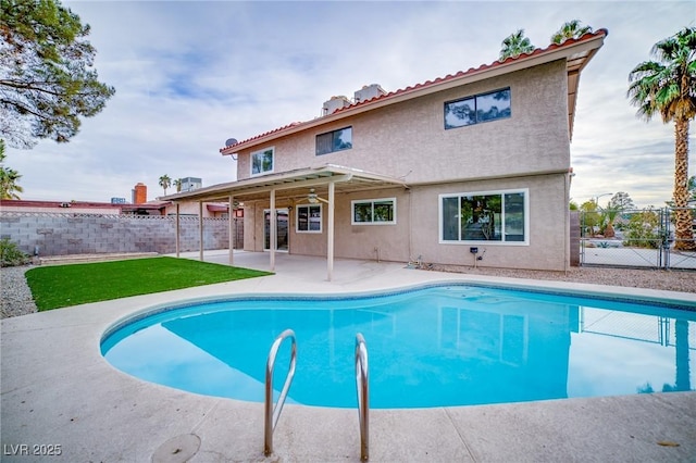 view of pool featuring a yard and a patio