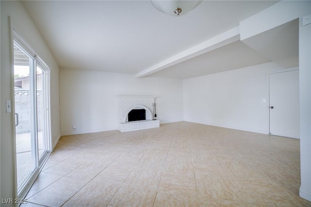 unfurnished living room featuring a fireplace, beam ceiling, and light tile patterned floors