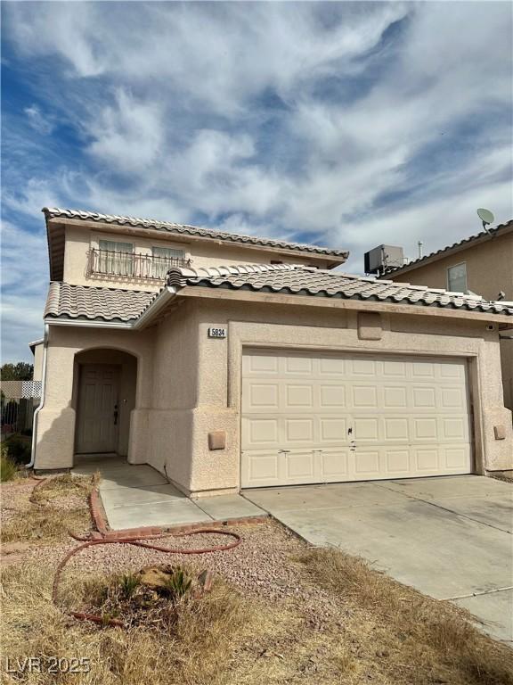 view of front of home with a balcony and a garage