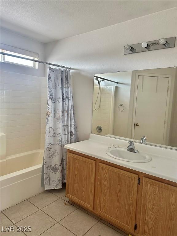 bathroom featuring vanity, tile patterned floors, a textured ceiling, and shower / tub combo with curtain