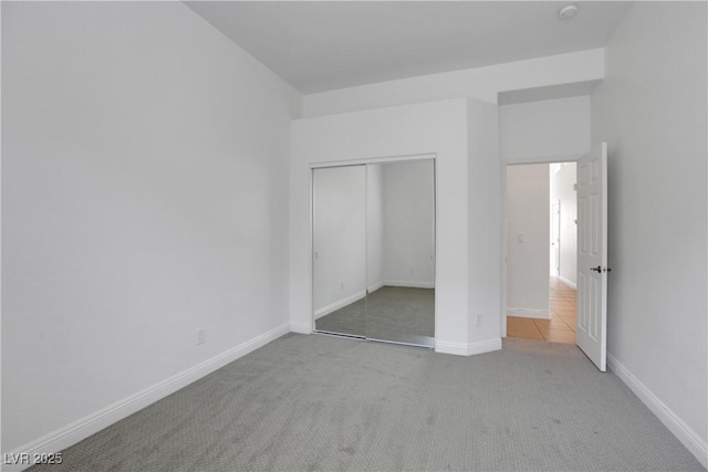 unfurnished bedroom featuring carpet floors and a closet