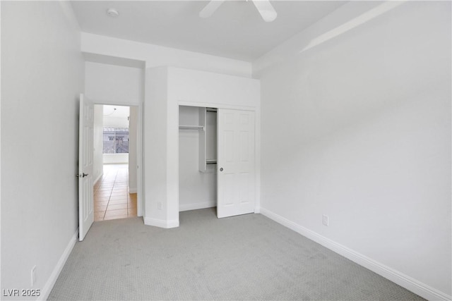 unfurnished bedroom featuring carpet floors, ceiling fan, and a closet