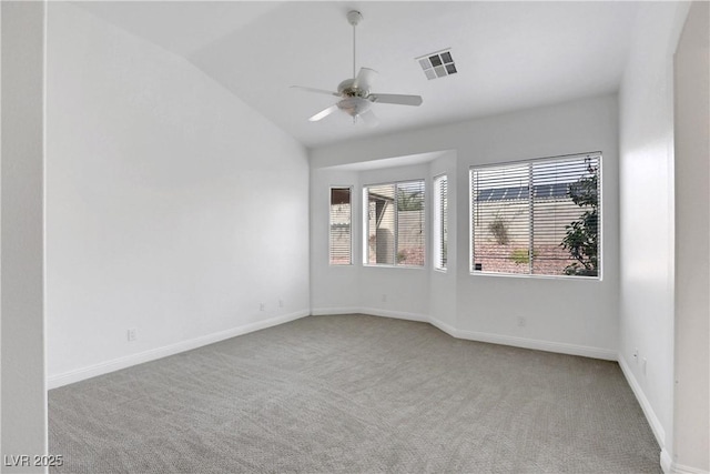 empty room with lofted ceiling, light carpet, and ceiling fan