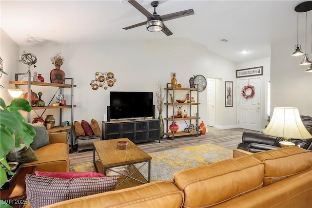 living room featuring ceiling fan, vaulted ceiling, and light hardwood / wood-style flooring