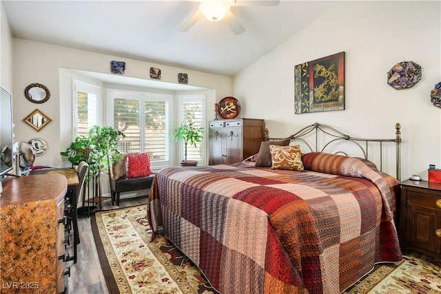 bedroom with ceiling fan, lofted ceiling, and light hardwood / wood-style floors