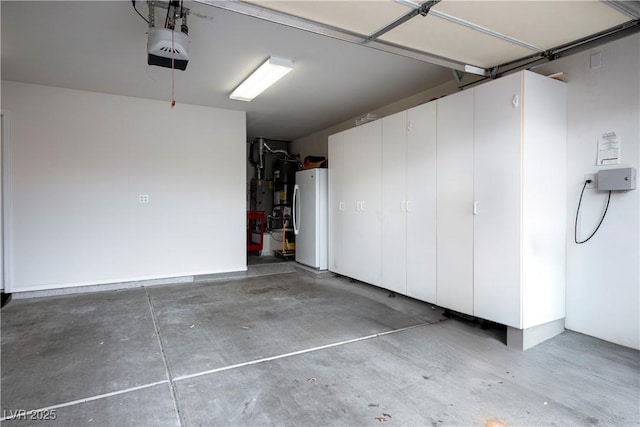 garage featuring water heater and white fridge