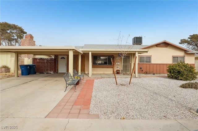 view of front of property with a carport and central air condition unit