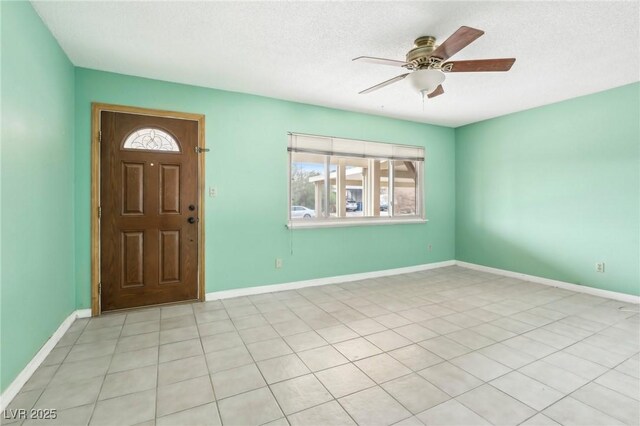 entrance foyer featuring a textured ceiling and ceiling fan