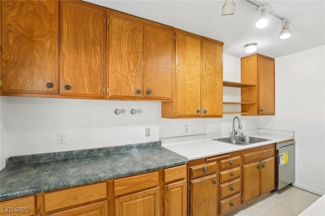 kitchen with sink, track lighting, and dishwashing machine