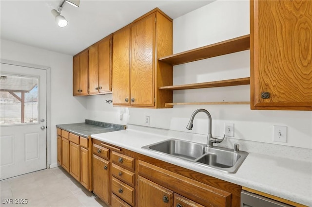 kitchen featuring dishwasher, rail lighting, and sink