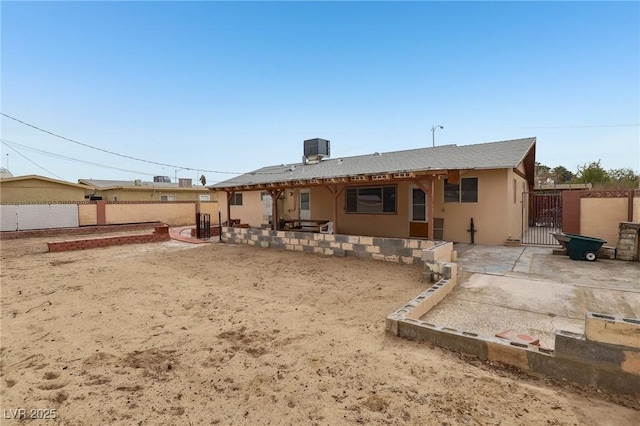 rear view of house featuring central AC and a patio area