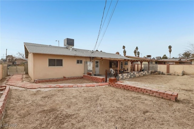 back of property featuring central AC and a patio area