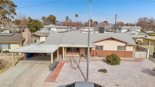 view of front of house with a carport and cooling unit