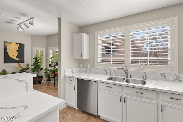 kitchen featuring white cabinetry, sink, and a wealth of natural light