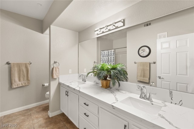 bathroom featuring vanity, curtained shower, tile patterned floors, and toilet