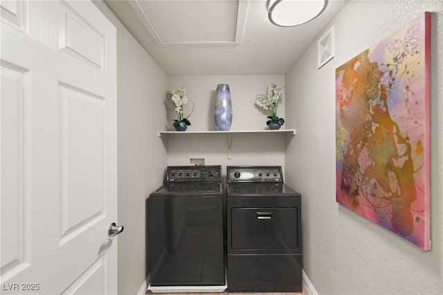 clothes washing area featuring separate washer and dryer