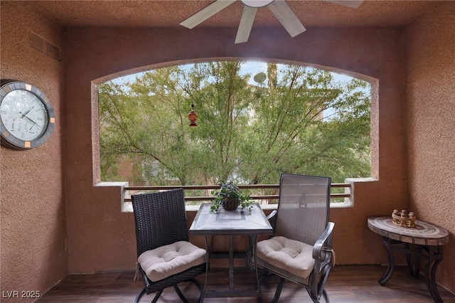 exterior space with ceiling fan and a balcony