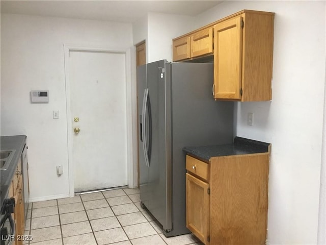 kitchen with stainless steel refrigerator with ice dispenser and light tile patterned floors