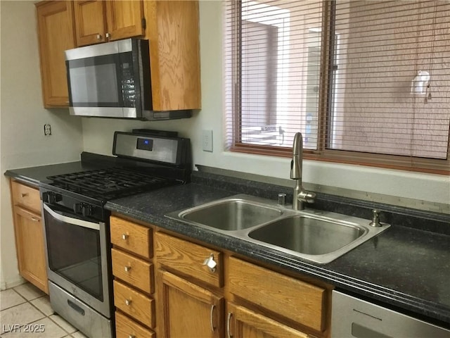 kitchen featuring light tile patterned flooring, stainless steel appliances, and sink