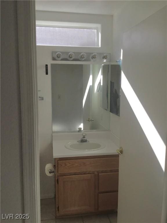 bathroom featuring vanity, tile patterned flooring, and plenty of natural light