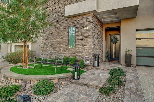 doorway to property with a lawn