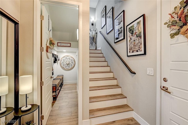 staircase with hardwood / wood-style floors