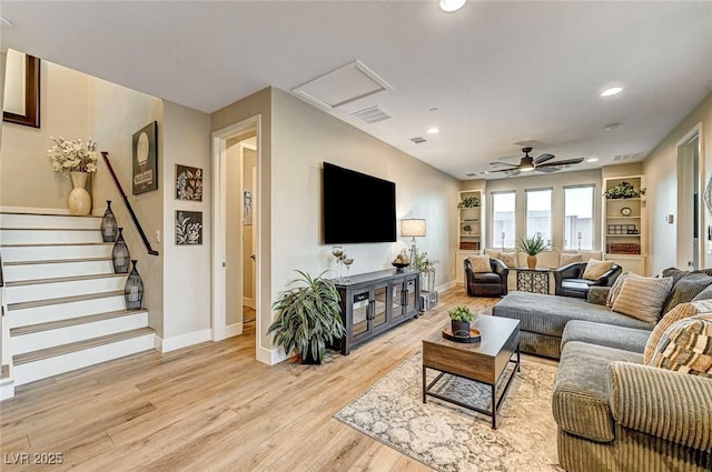 living room featuring ceiling fan and light hardwood / wood-style floors