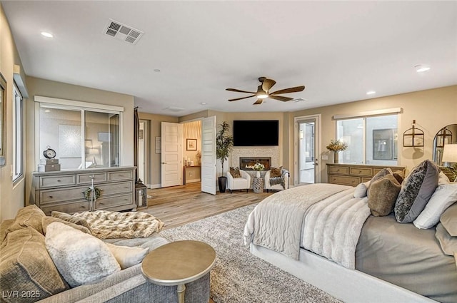 bedroom featuring ceiling fan, access to exterior, and light hardwood / wood-style flooring