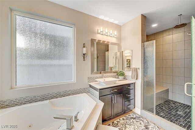 bathroom with vanity and separate shower and tub