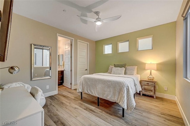 bedroom with ceiling fan, connected bathroom, and light hardwood / wood-style floors